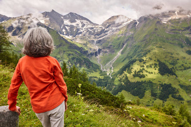 istock Grossglockner. Serpentine alpine road viewpoint. Green forest and waterfall. Austria 1714795417