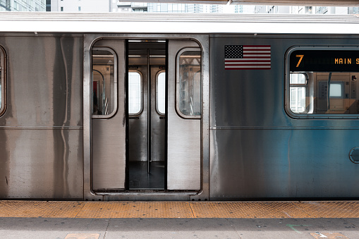 New York City subway train departing from a station.