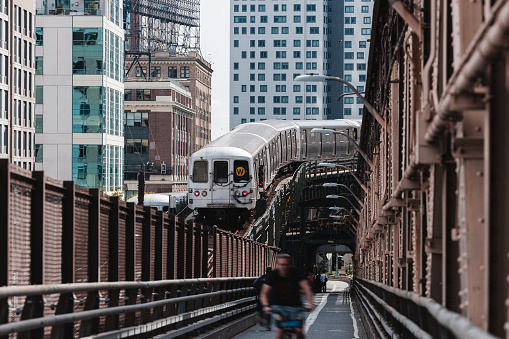 Typical New York City subway train between buildings approaching to a station.