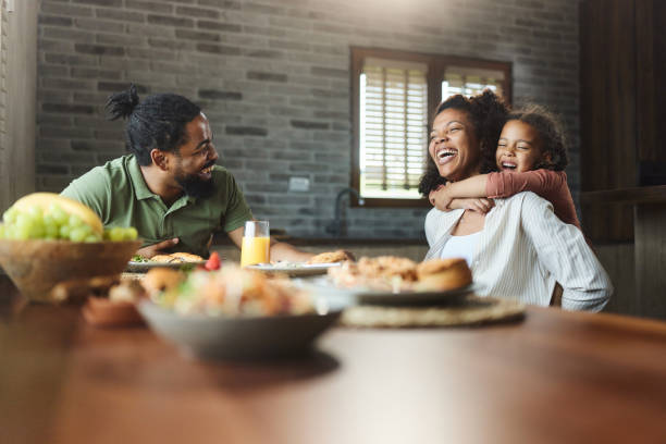 istock Cheerful black family having fun during breakfast at dining table. 1714805530