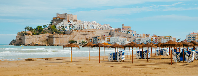 a view of Norte beach in Peniscola, Spain, with the old town and its castle in the background, in a panoramic format to use as web banner or header