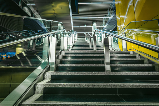 Stairs in a public building of crossrail station viewed from outside, Canary Wharf financial district, London, UK