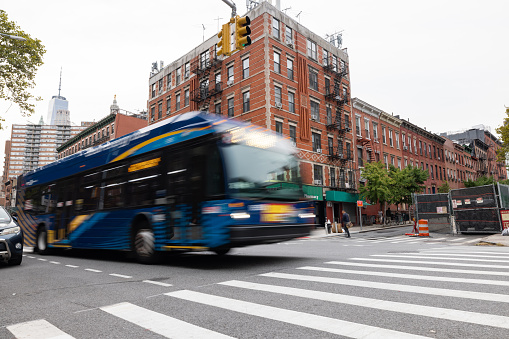 Blurred public bus transportation in lower Manhattan, Chinatown in New York City.