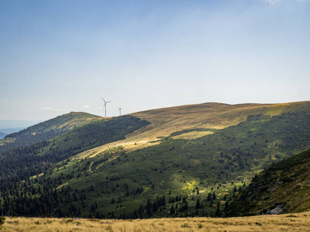 istock Wind turbines on a golden hill during summer 1714824022