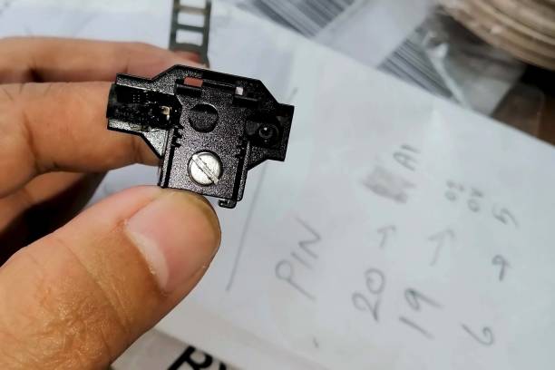 istock Close up electrician repairing a proximity sensor on hand because burned from short circuit with a drawing a pin out on the white paper. 1714825650