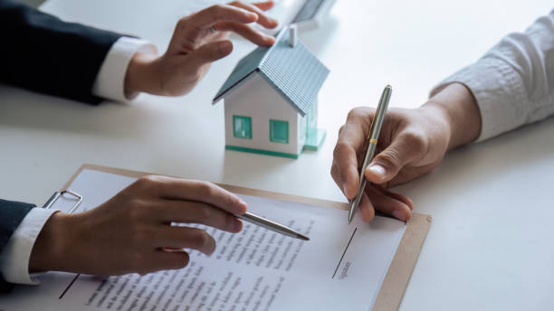 istock Professional real estate agent guiding and explaining the document process to the customer 1714836852