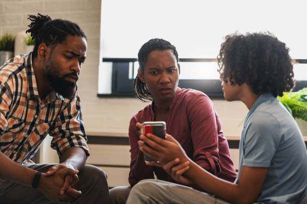 Parents talking with their teenage son about his smartphone usage