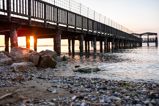 A beautiful sunset on Lago di Garda near the wooden jetty.