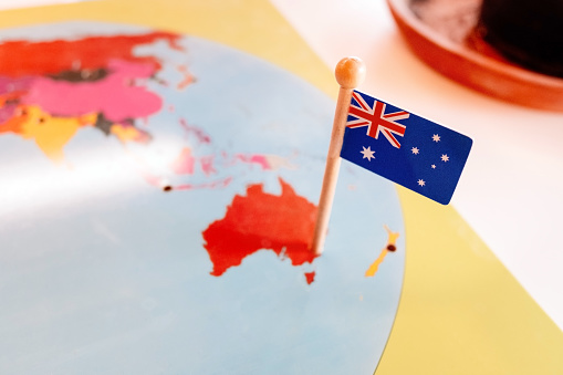 An Australian flag pinned to a Montessori map of Oceania continent in a school.