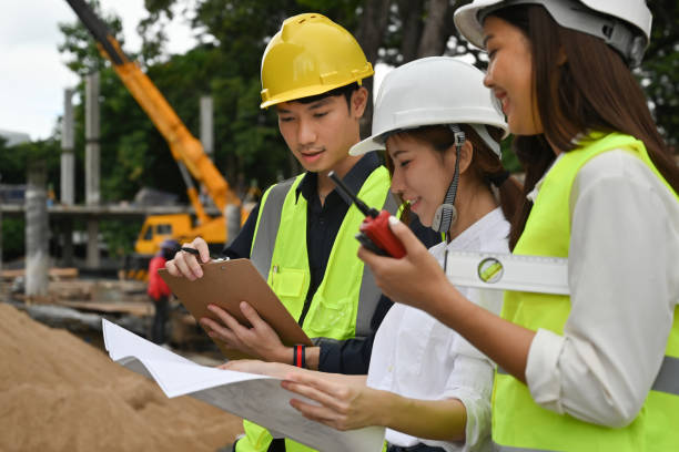 istock Diverse team of specialists on construction site discussing about building Project. 1714880354