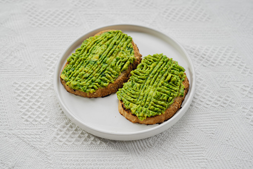 Healthy food, avocado toast on white plate