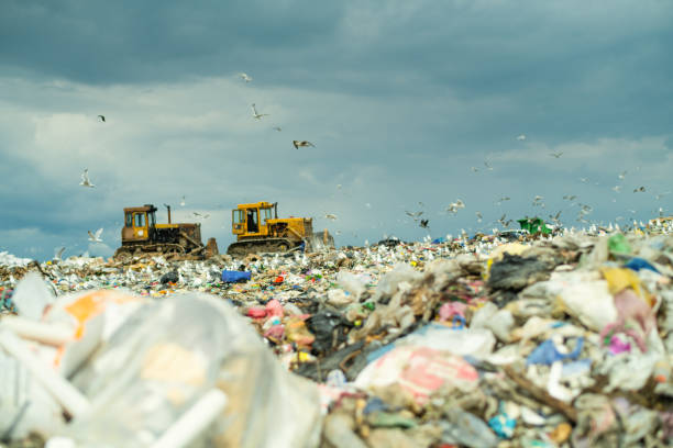 istock Garbage dump and bulldozers. Environmental damage, air and water pollution and ecology crisis concept. 1714901663