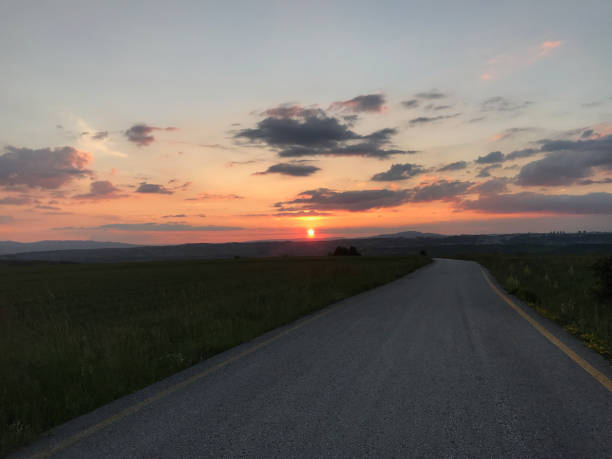istock Golden sunset and country road 1714902054