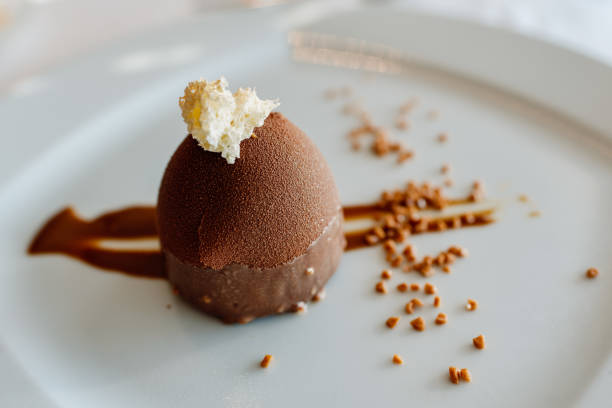 istock Elegant chocolate dessert with cream on a luxurious plate. 1714902272