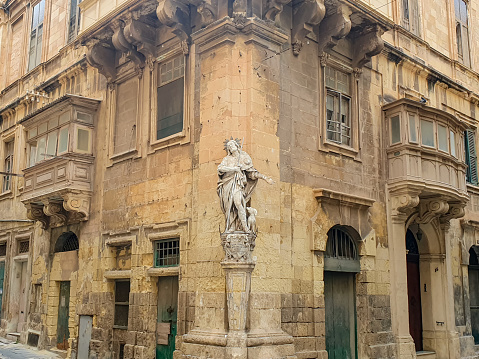 The traditional Maltese corners of houses decorated with statues of saints in Valletta, the Capital city of Malta