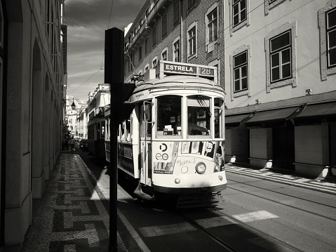 Lisbon, Portugal - June 10, 2023: An old traditional tram runs up a street in Lisbon downtown.