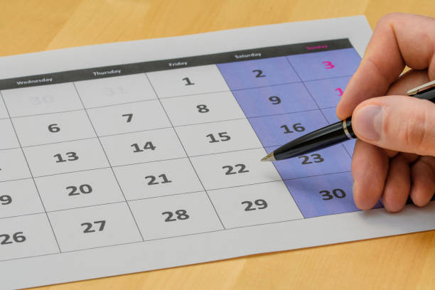istock Calendar page lying on the desk, marking the date with a pen 1714906339