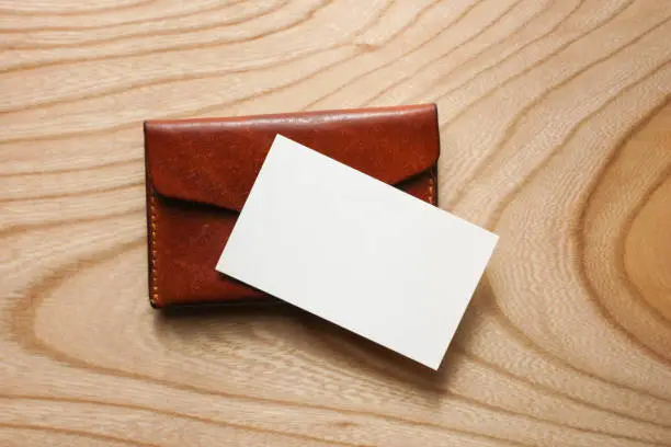 blank business card with leather card case on the wooden table