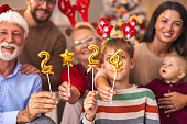 Family holding numbers 2024 representing the upcoming New Year