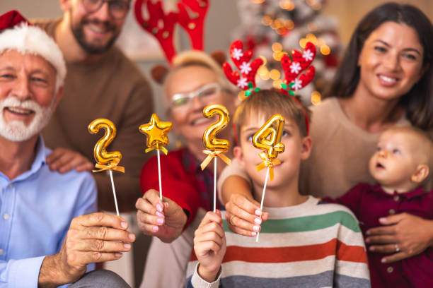 family holding numbers 2024 representing the upcoming new year - new year people family offspring imagens e fotografias de stock