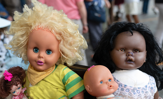 Dolls representing people of different races are sold at the flea market.