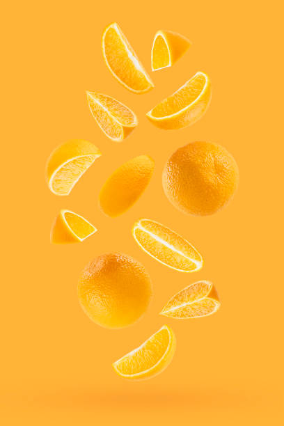 istock Bright oranges as flow fly or fall as art composition. Whole, half, quarter pieces fruits on pastel orange background with shadow. Tropical fruits for advertising, design, label product, poster, card. 1714944339