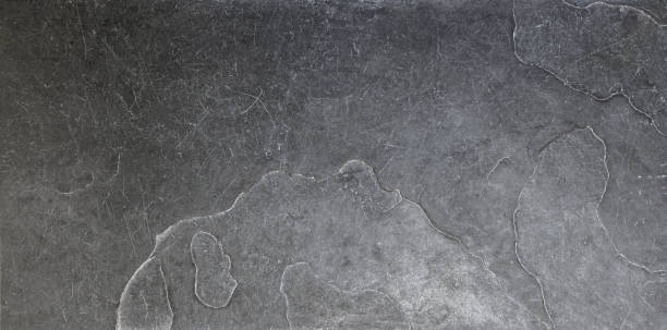istock Black abstract textured structured natural stone background, scratched floor tiles 1714969474