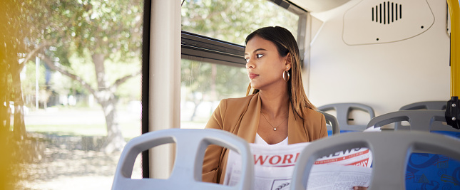 Woman on a bus, transport and travel with newspaper, commute to work or university, city and traffic. Transportation, vehicle and student, day trip and reading material with metro and public service