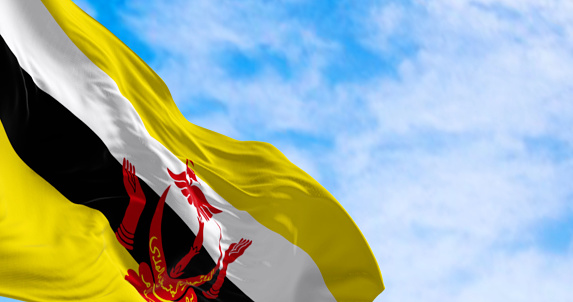 National flag of Brunei waving in the wind on a clear day. Brunei Darussalam is a country in the Southeast Asia. 3d illustration render. Fluttering fabric. Selective focus