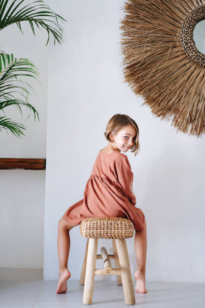 istock Girl sitting astride a stool, turning around looking at the camera 1714989533