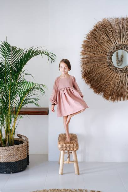 istock Girl balancing on one leg while standing on a stool 1714995366