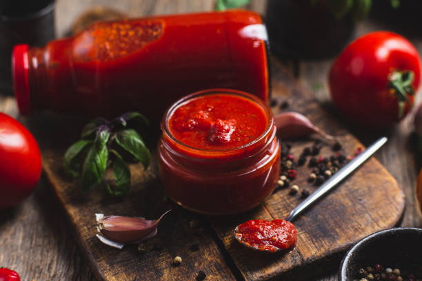 istock Ketchup in a jar. Tomato sauce on a dark background 1715004955