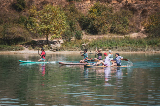 istock Group of Friends Paddle Boarding (sup) on River 1715006144