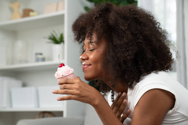 istock Funny African on mess face presenting cupcake in concept special. Tastemaker. 1715011136
