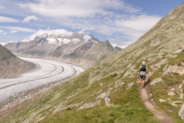istock Trail runner bounds along mountain trail 1715011699