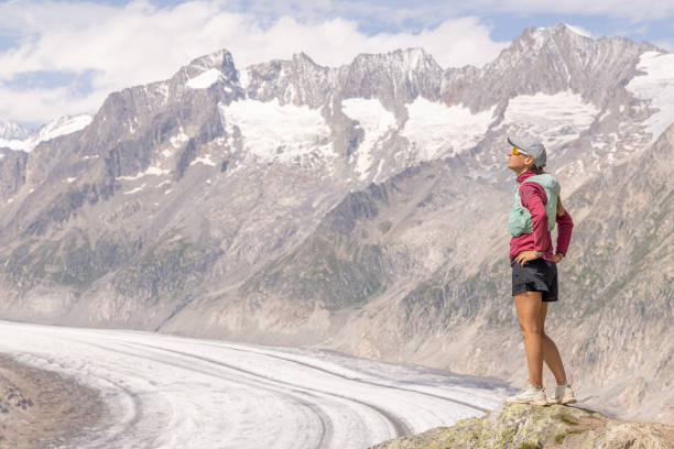 istock Female trail runner takes a break above glacier 1715012453