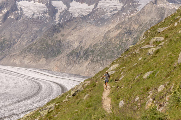 istock Trail runner bounds along mountain trail 1715012874