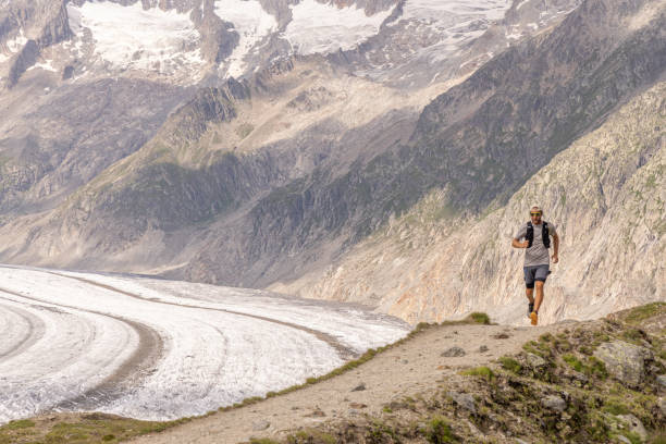 istock Trail runner bounds along mountain trail 1715015783