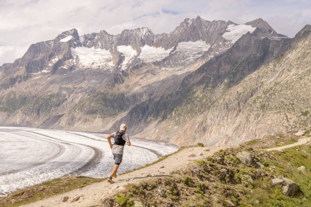 istock Trail runner bounds along mountain trail 1715018042