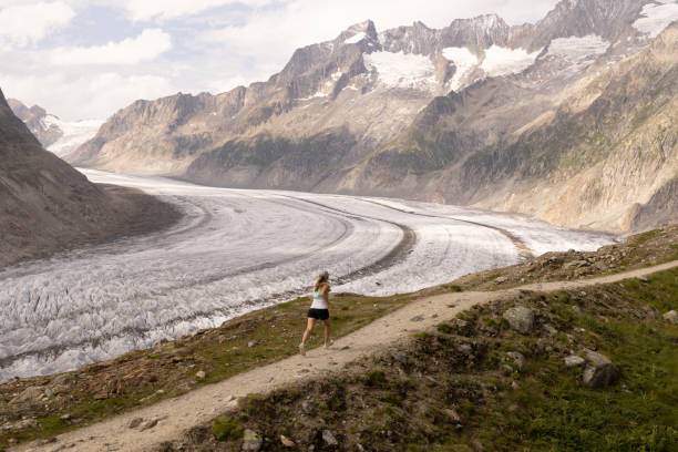 istock Female trail runner bounds along mountain trail 1715018044
