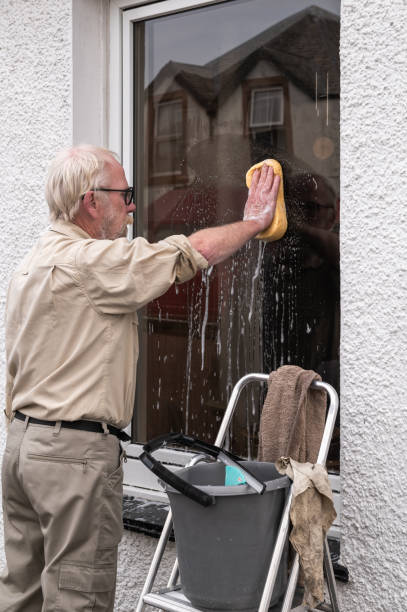 istock Senior man using a sponge to clean his window 1715022481