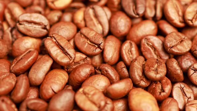 Bright background with roasted coffee beans.