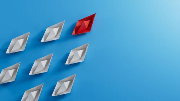 istock Leadership concept with red paper boat leading among white.3D rendering on blue background. 1715050906