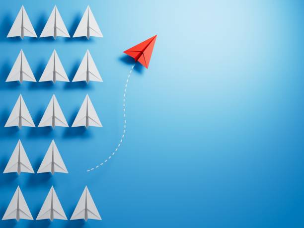 istock Leaderairplane concept with red paper plane leading among white.3D rendering on blue background. 1715051466