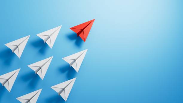 istock Leaderairplane concept with red paper plane leading among white.3D rendering on blue background. 1715051467