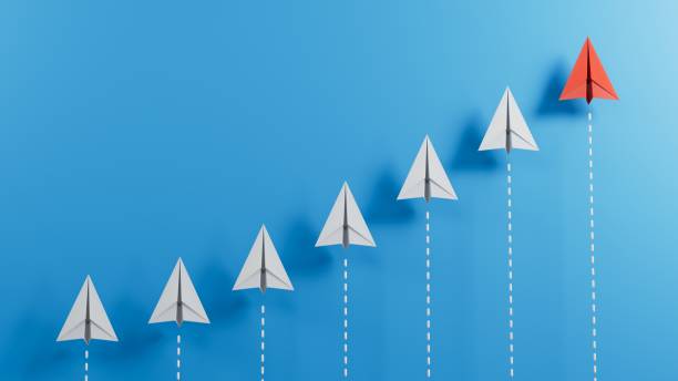 istock Leaderairplane concept with red paper plane leading among white on blue background with copy space.3D rendering on blue background. 1715052004