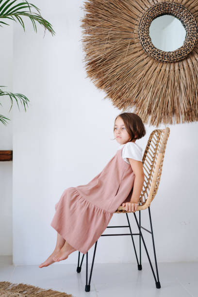 istock Pensive child sitting on a chair 1715054780