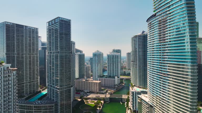 Miami Brickell in Florida, USA. View from above of Miami River between concrete and glass skyscraper buildings in city downtown. American megapolis with business financial district on sunny day