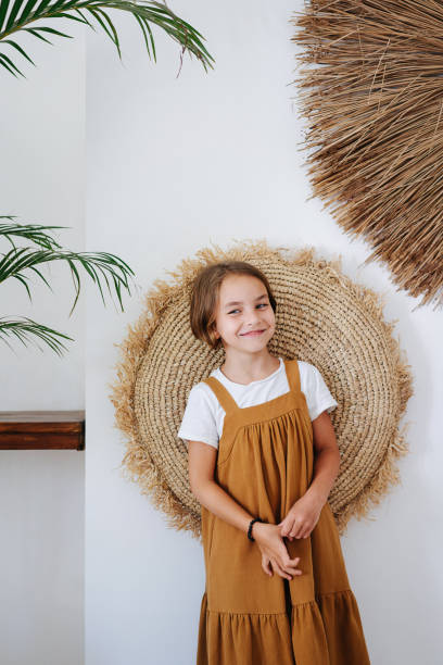istock A girl with sly eyes stands against a wall 1715058139