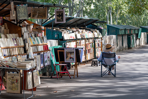 Paris, France - October 2, 2023: Parisian Bouquiniste display. Bouquinistes are booksellers of used and antiquarian books, posters and souvenirs, who ply their trade along the banks of the Seine river